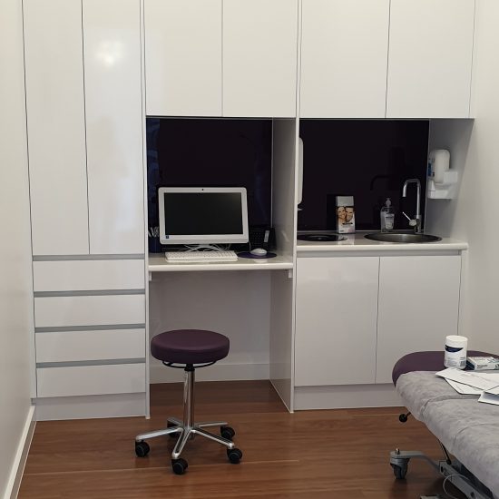 Custom joinery, 2 pac finish, white 2 pac, retail design, commercial design, cabinet design, glass splashback, purple glass splashback, treatment room fitout