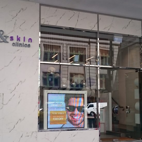 Shopfront design, stone cladding, Dekton cladding, polished steel window frames, retail design, commercial design, custom joinery, 2 pac finish, white 2 pac, product display