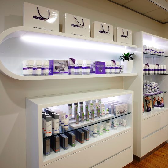 Custom joinery, 2 pac finish, white 2 pac, retail design, commercial design, backlit shelving, cabinet design, product display, 3D wall panels