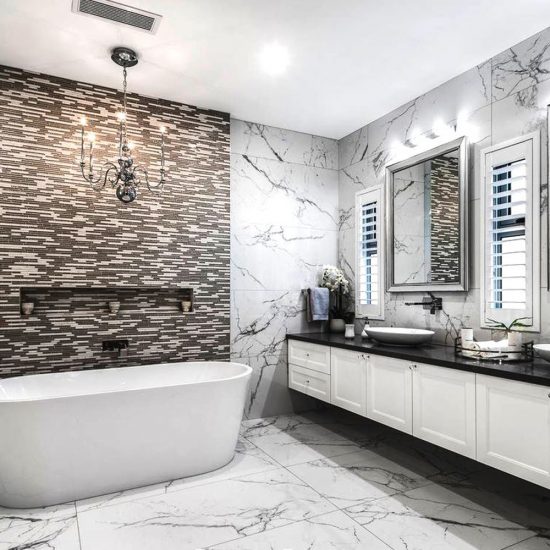 bathroom design, master ensuite, marble tiles, calacutta tiles, custom joinery, floating vanity, marble mosaic tiles, chandelier over bath, wall niche, free standing bath, shaving cabinets, mirror shaving cabinets, framed mirror shaving cabinets, Hamptons bathroom, shaker cabinet doors, countertop basin, luxury bathroom