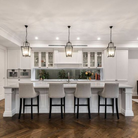 full design service kitchen design, classic kitchen, luxury kitchen, formal kitchen, Hamptons kitchen, upholstered stools, pendant lights, Hamptons lighting, black lanterns, lighting over island, timber floor, herringbone flooring
