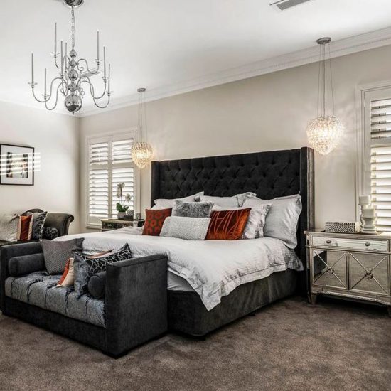 master bedroom, bedroom decorating, upholstered bedhead, custom bedhead, button back bedhead, diamond buttoned bedhead, custom cushions, bedside tables, mirror bedside tables, pendant lights, pendant lights beside bed, pendant lights over bedside table, lights over bedsides, pendants over bedsides, custom bench seat, chaise, chandelier, silver chandelier, shutters