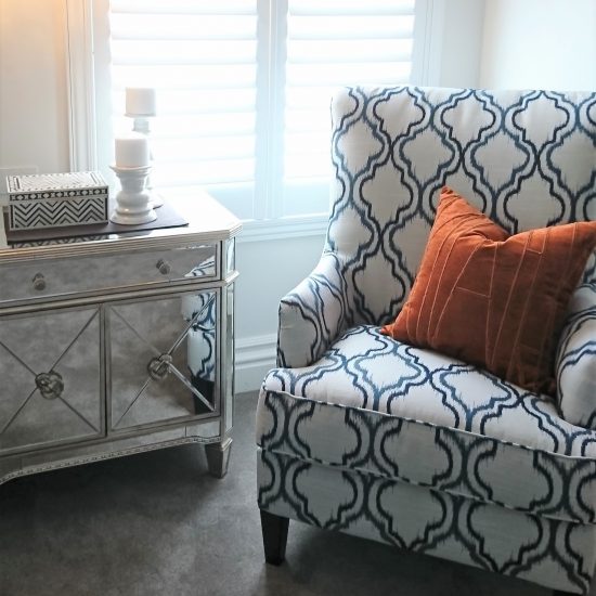 mirror bedside table, upholstered armchair, bedroom chair, rust cushion