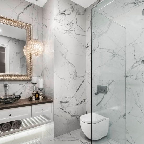 bathroom design, powder room, marble tiles, calacutta tiles, Hamptons style, Hamptons vanity, custom vanity, mirror, decorative mirror, powder room mirror, crystal basin, pendant light, crystal pendant light, frameless shower, wall hung toilet, Geberit toilet, in-wall cistern