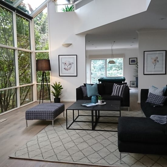 Family room, family room décor, coffee table, coffee table cluster, diamond pattern rug, floor rug, custom cushions, tripod floor lamp, contemporary family room