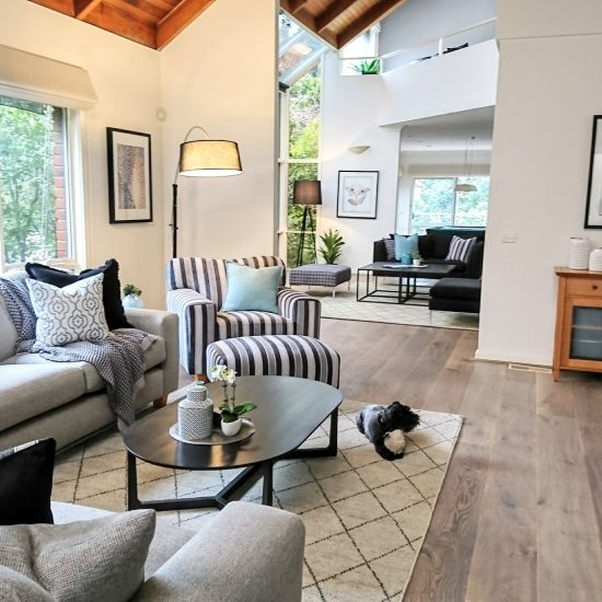 Lounge room, casual lounge, diamond pattern rug, oval coffee table, striped armchair, blck and white décor, arc floor lamp
