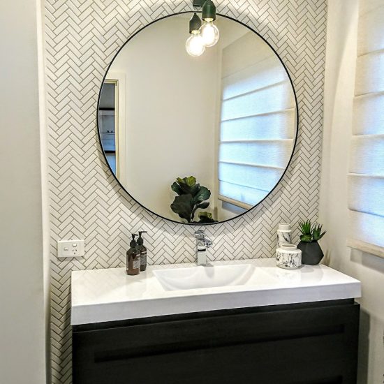 Powder room, contemporary powder room, round mirror, round black mirror in powder room, powder room lighting, herringbone tiles, herringbone mosaics, feature tiles, floating vanity