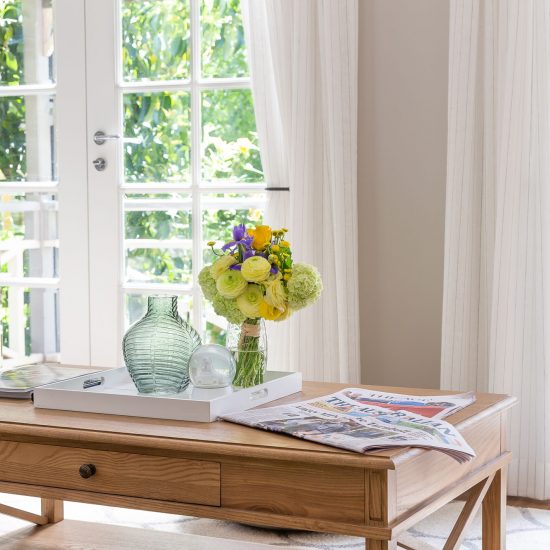 Hamptons style, Hamptons lounge room, timber coffee table, floor rug, diamond patterned rug, white curtains, sheer curtains, iron holdback