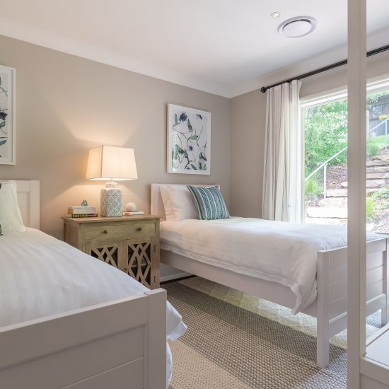 Hamptons style, Hamptons bedroom, white timber bed, bedroom floor rug, white curtains, sheer curtains, iron curtain rod, timber bedside cabinet, wall art